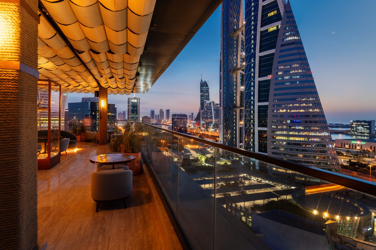 Brasero Atlántico Bahrain: The rooftop terrace at dusk, with the Manama skyline behind it